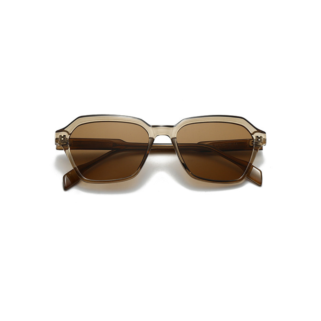 Sunglasses with brown lenses and gold frame on a white background