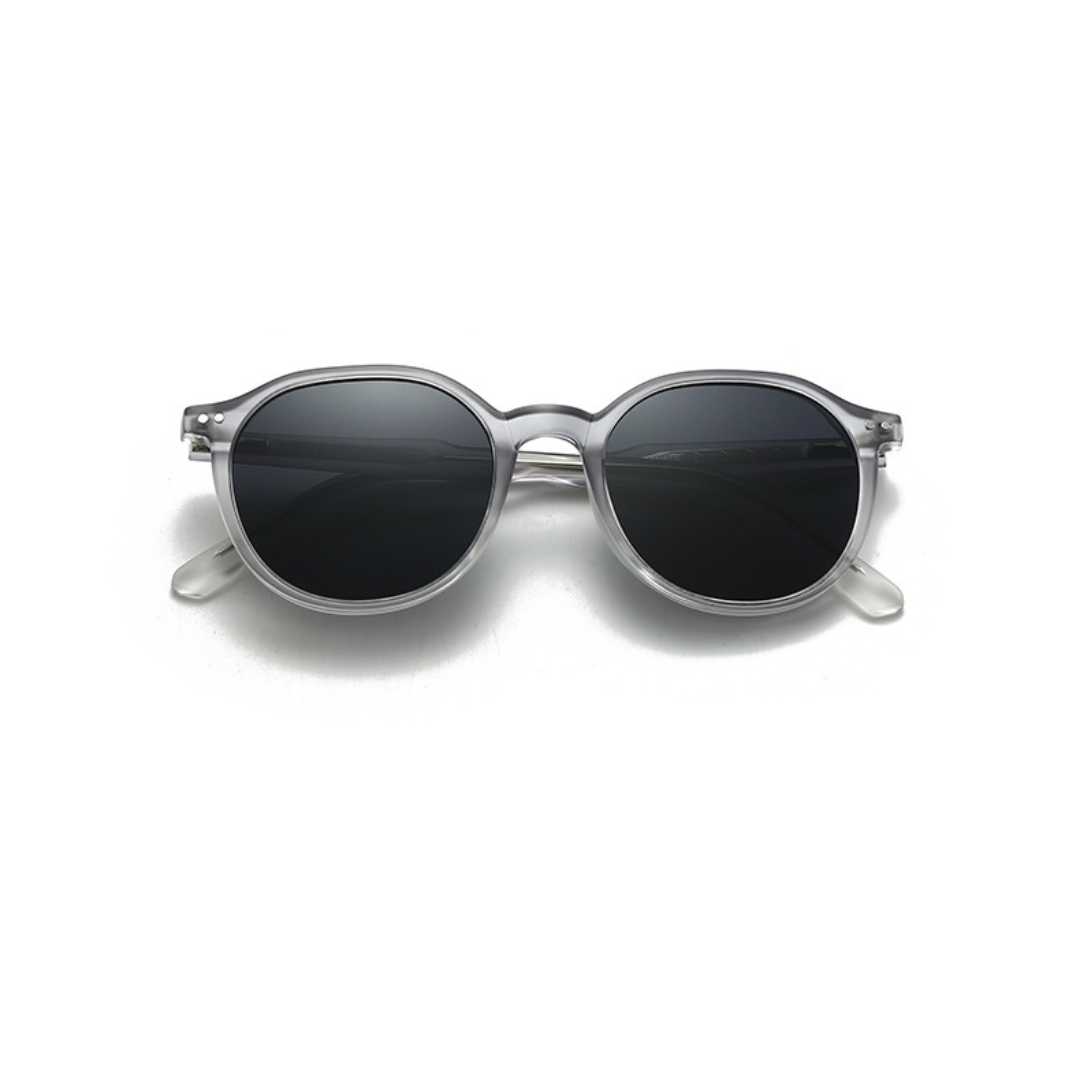 Round sunglasses with dark lenses and clear frame on a white background